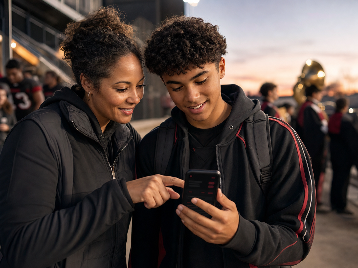 A parent and high-school student confidently coordinating school activities together on a phone